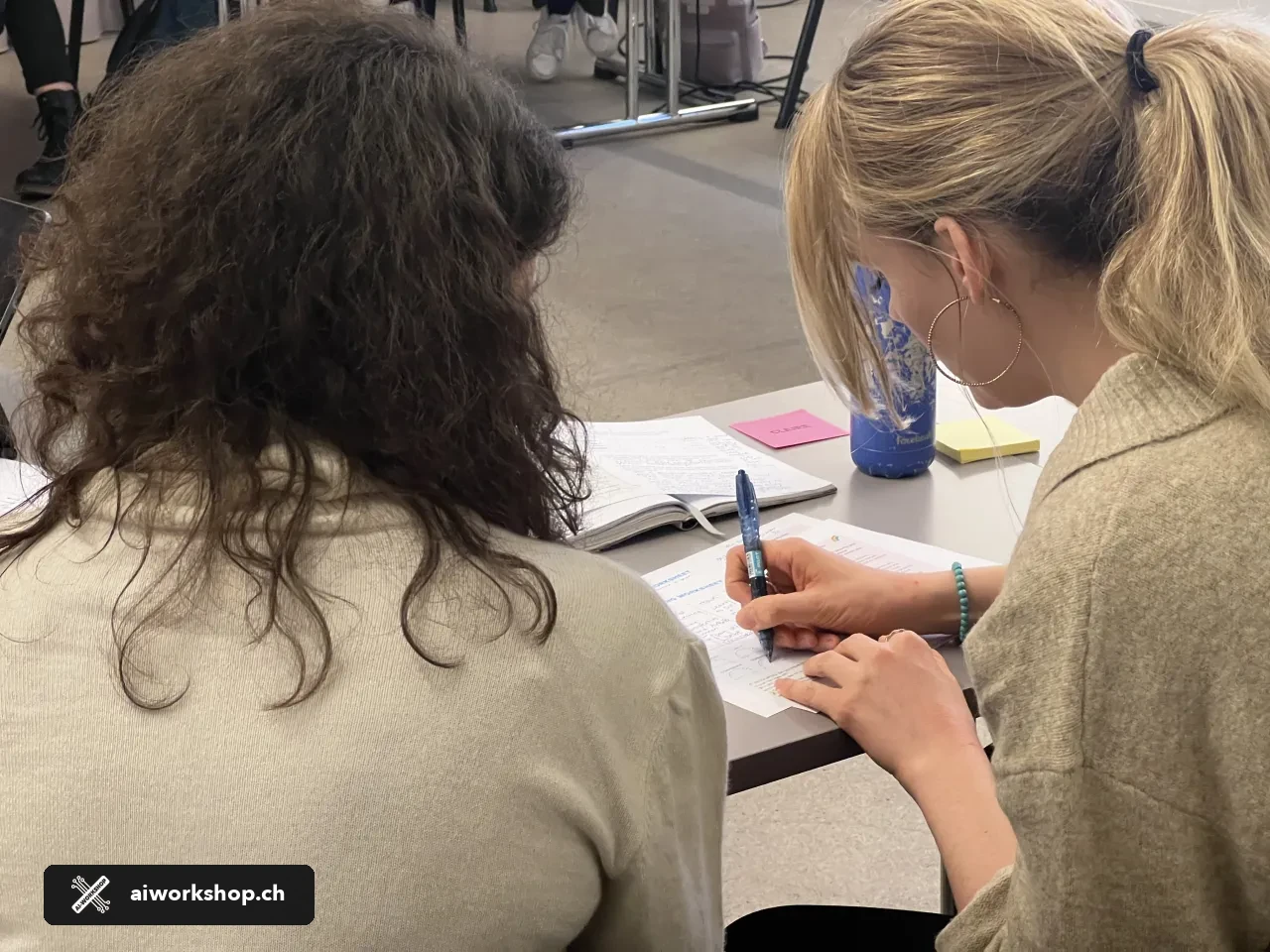 Two participants complete a practical AI for HR exercise during a workshop in Zürich